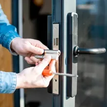close up of hands working on door handles