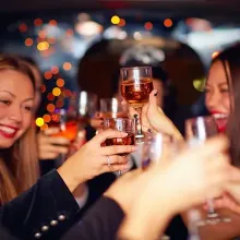 group of young people celebrating with wine glasses